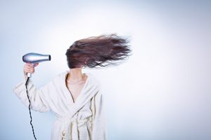 woman blowdrying hair
